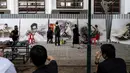 Para mahasiswa seni dari Universitas Silpakorn menyelesaikan lukisan gambar mendiang raja Bhumibol Adulyadej, disaksikan beberapa pengunjung di Bangkok, Senin (17/10). (Reuters/Athit Perawongmetha)