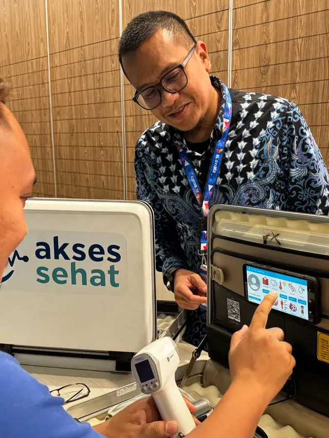 Chief Enterprise Business Officer XL Axiata, Feby Sallyanto (kanan) mencoba perangkat XL Axiata Akses Sehat di sela-sela acara peluncuran "XL Axiata Akses Sehat"