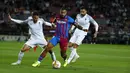 Penyerang Barcelona, Memphis Depay (tengah) mengontrol bola dibayangi pemain Granada pada lanjutan La Liga di Camp Nou, Selasa (21/9/2021) dini hari WIB. Barcelona dipaksa bermain imbang 1-1 oleh tamunya Granada. (AP Photo/Joan Monfort)