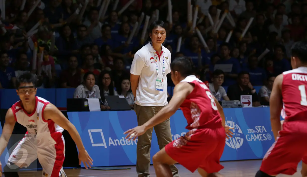 Pelatih tim basket Indonesia, Fictor Roring (kedua kiri) memerhatikan laga timnya melawan Singapura di semifinal SEA Games ke-28 di OCBC Arena Singapore, Minggu (14/6/2015). Indonesia unggul 87-74 atas Singapura. (Liputan6.com/Helmi Fithriansyah)
