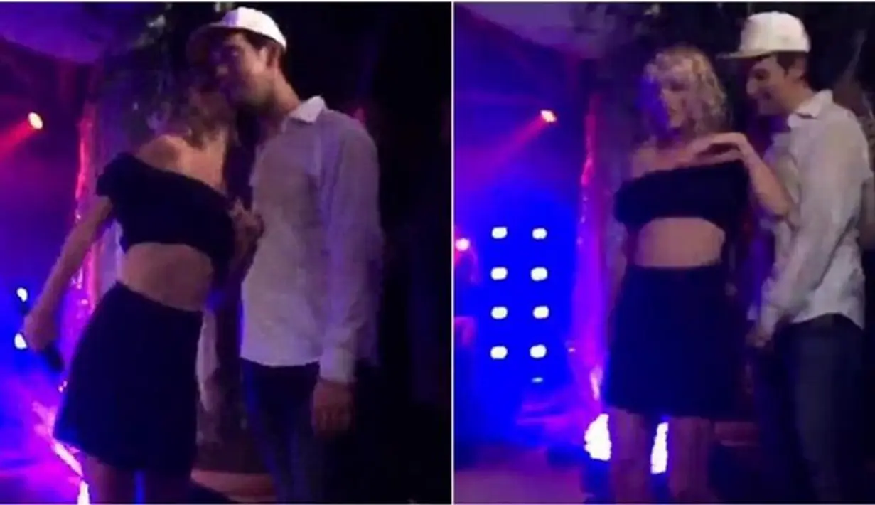Sambil menari di atas panggung, Taylor Swift yang mengenakan baju crop top dan sepatu berwarna putih. Ia berjalan menyelusuri panggung dan tiba-tiba mencium seorang pria yang tengah berdiri di sana. (Dailymail/Bintang.com)