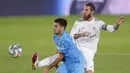 Pemain Real Madrid Sergio Ramos (kanan) berebut bola dengan pemain Valencia Maxi Gomez pada pertandingan La Liga Spanyol di Estadio Alfredo Di Stefano, Madrid, Spanyol, Kamis (18/6/2020). Real Madrid menang 3-0 lewat dua gol Karim Benzema dan satu gol Marco Asensio. (AP Photo Manu Fernandez)