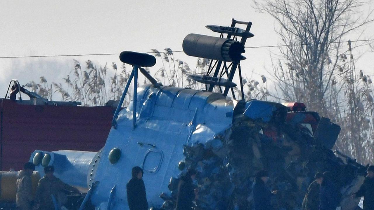 Petugas melakukan pemeriksaan puing-puing helikopter militer Kyrgyzstan Mi-8-MTV setelah jatuh di pinggiran Bishkek pada Rabu 17 Januari 2024. <br>