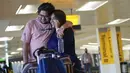 Jolly Dave menelepon setelah tiba dari India dan bertemu kembali dengan pacarnya, Nirmit Shelat, di Bandara Internasional Newark Liberty, New Jersey, Senin (8/11/2021). AS membuka kembali perbatasannya untuk pengunjung asing, mengakhiri larangan masuk selama 20 bulan. (AP Photo/Seth Wenig)