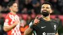 Penyerang Liverpool, Mohamed Salah merayakan golnya saat pertandingan matchday 6 Liga Champions 2024/2025 melawan Girona FC di stadion Montilivi, Girona pada Selasa 10 Desember 2024 waktu setempat atau Rabu 11 Desember 2024 dini hari Waktu Indonesia Barat. (Josep LAGO/AFP)