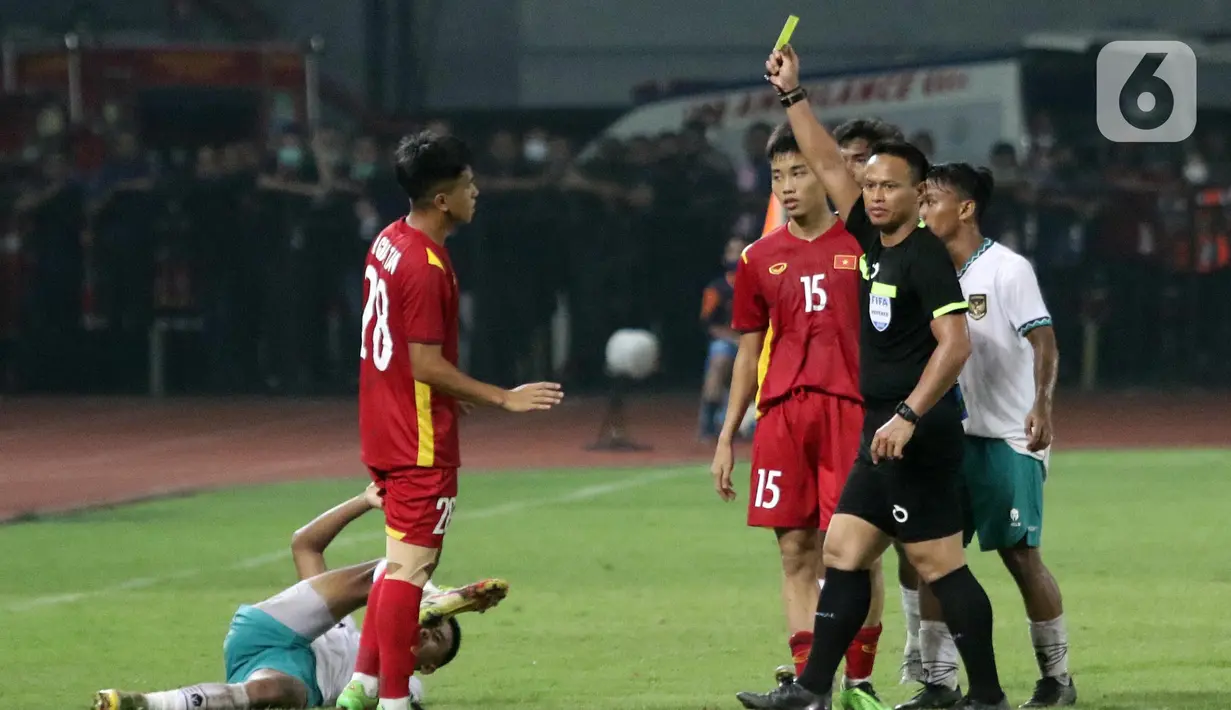 Wasit memberikan kartu kuning untuk Nguyen Gian Tan saat laga Vietnam U-19 melawan Timnas Indonesia U-19 pada kualifikasi grup A Piala AFF U-19 2022 di Stadion Patriot Candrabhaga, Bekasi, Jawa Barat, Sabtu (2/7/2022). Timnas Indonesia U-19 gagal membungkam Vietnam U-19 setelah bermain imbang 0-0. (Liputan6.com/Helmi Fithriansyah)