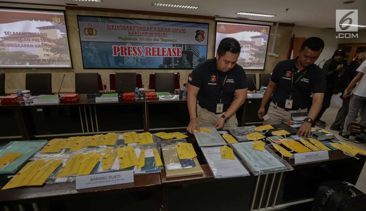 Petugas memperlihatkan barang bukti paspor saat rilis pengungkapan kasus tindak pidana perdagangan orang, Jakarta, Kamis (21/12). Selama periode tahun 2017, jaringan tersebut telah memakan korban 1.083 orang. (Liputan6.com/Faizal Fanani)