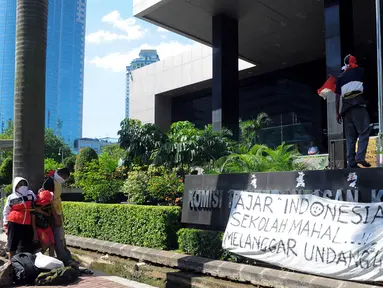 Sebuah keluarga melakukan aksi demo di depan gedung KPK, Jakarta, Senin (14/7/14). (Liputan6.com/Faisal R Syam)