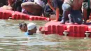 Wagub DKI Jakarta Sandiaga Uno mencapai garis finish saat bertanding melawan Menteri KKP, Susi Pudjiastuti melintasi danau sepanjang 1k selama Festival Danau Sunter di Jakarta, Minggu (25/2). (Liputan6.com/Angga Yuniar)