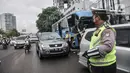 Petugas kepolisian menilang pengendara mobil yang melanggar aturan ganjil genap di Jalan MT Haryono, Jakarta, Kamis (28/10/2021). Para pelanggar sistem ganjil genap dikenakan sanksi tilang berupa denda maksimal Rp500 ribu. (merdeka.com/Iqbal S Nugroho)