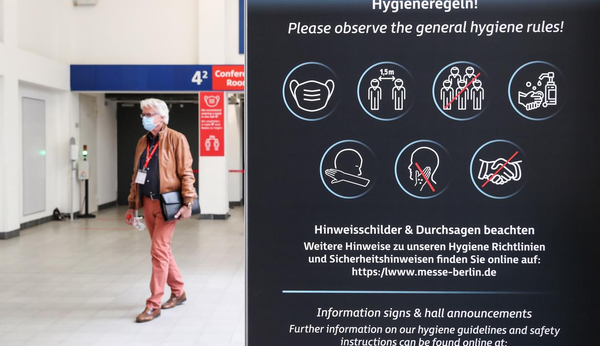 Pengunjung melewati papan bertuliskan instruksi kebersihan di sebuah area ekshibisi dalam pameran IFA 2020 di ibu kota Jerman, 3 September 2020. Pameran perdagangan teknologi itu dibuka di Berlin dengan skala yang diperkecil akibat krisis virus corona yang masih berlangsung (Xinhua/Shan Yuqi)