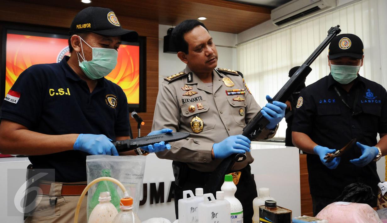 Kepala Biro Penmas Mabes Polri Kombes Pol Rikwanto (tengah) melihat barang bukti senapan angin terduga teroris di Jakarta, Jumat (25/11). Tim Densus 88 menahan satu orang terduga teroris berikut bahan racikan bom. (Liputan6.com/Helmi Fithriansyah)