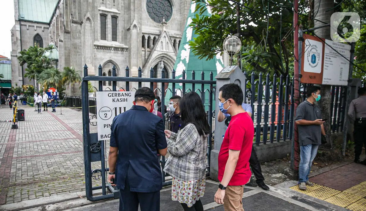 Para Jemaat memperlihatkan bukti pendaftaran untuk mengikuti ibadah di Gereja Katedral, Jakarta, Kamis (24/12/2020). Kapasitas gereja untuk ibadat misa Natal sebanyak 309 kursi, yaitu 20 persen dari kapasitas Gereja Katedral. (Liputan6.com/Faizal Fanani)