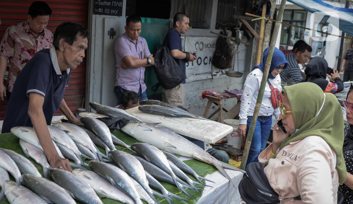Pedagang ikan bandeng melayani pembeli di kawasan Rawa Belong, Jakarta, Selasa (21/1/2020). Bandeng yang biasanya menjadi hidangan khas saat Tahun Baru Imlek tersebut mulai ramai diperdagangkan di Rawa Belong. (Liputan.com/Faizal Fanani)