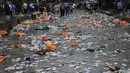 Suporter Skotlandia membantu membersihkan sampah yang ditinggalkan fans yang berpesta jelang pertandingan grup D Euro 2020 melawan Inggris di London, Jumat (18/6/2021). (AP Photo/Kirsty Wigglesworth)