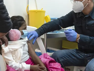 Petugas medis bersiap memberikan vaksin covid-19 kepada seorang anak di ibu kota Siprus, Nicosia, Minggu (2/1/2022). Siprus memulai vaksinasi untuk anak-anak berusia antara 5 hingga 11 tahun, di tengah lonjakan tajam kasus virus corona. (Iakovos Hatzistavrou / AFP)