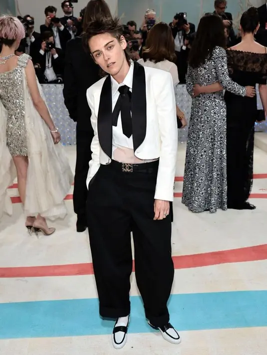 Gaya Boyish Kristen Stewart makin keren dengan sentuhan hitam putih. Kemeja putih ngatung dipasangkan dengan cropped blazer dan dasi. [@officialmetgala]