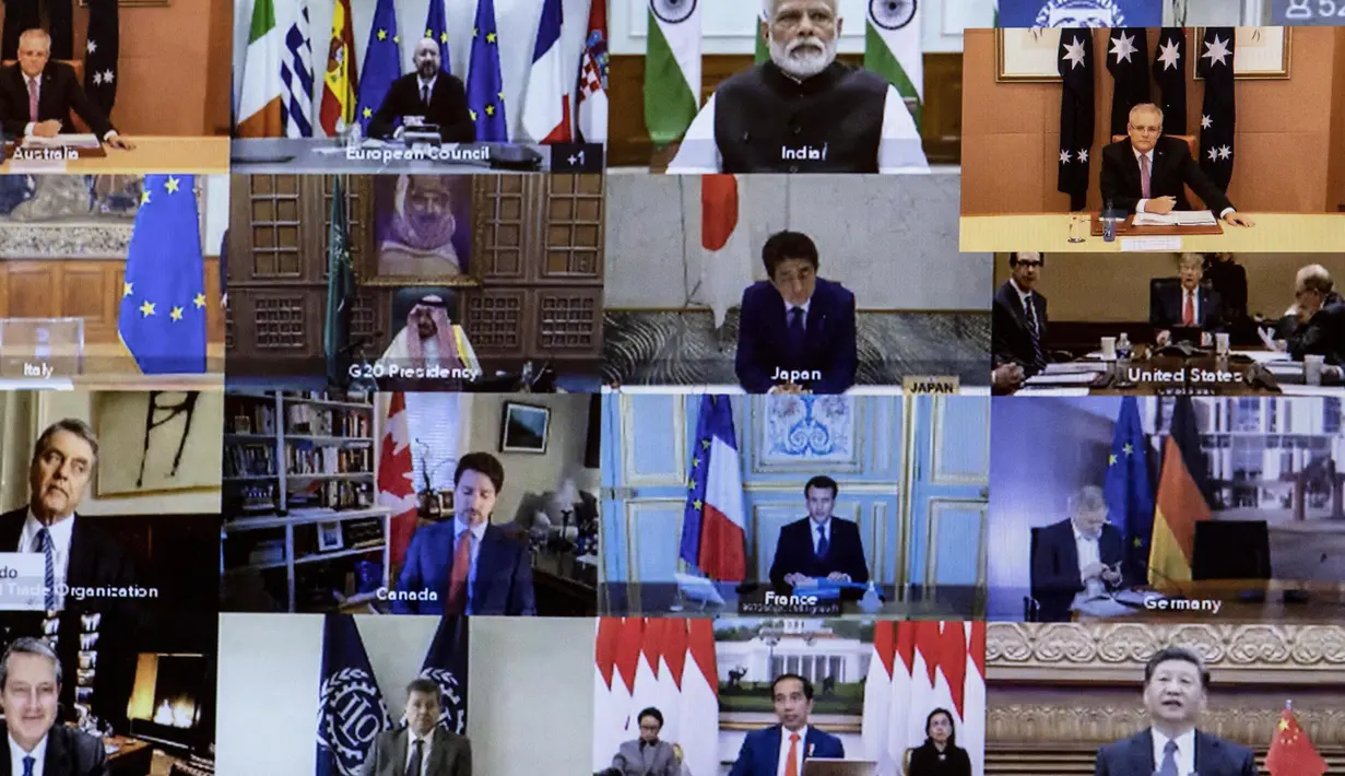 Sejumlah pemimpin dunia terlihat pada layar saat mengikuti KTT Luar Biasa G20 secara virtual dari Canberra, Australia, Kamis (26/3/2020). Para pemimpin dunia mengkoordinasikan respons global terhadap pandemi virus corona COVID-19. (Gary Ramage/POOL/AFP)