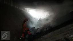 Pasukan oranye memeriksa tumpukan sampah yang berada di bawah Fly over jalan Dewi Sartika, Cawang, Jakarta, Rabu (19/4). (Liputan6.com/Gempur M. Surya)