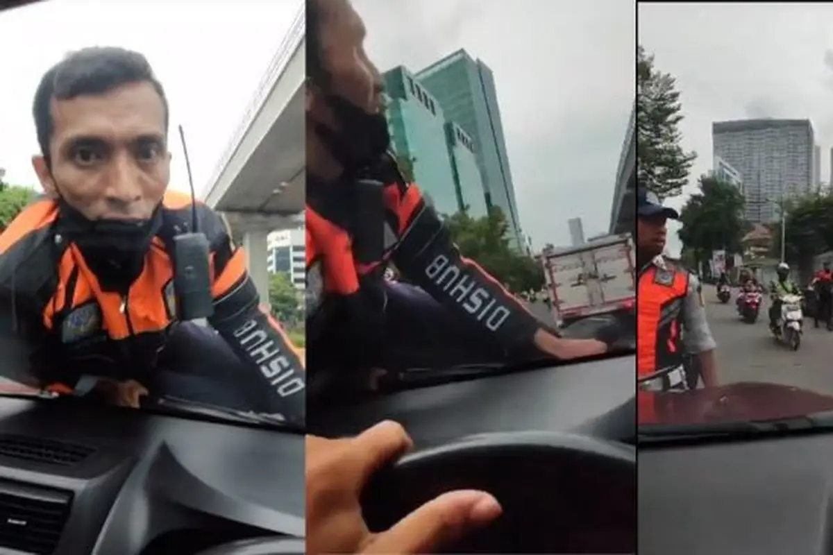 Petugas Dishub di Atas Kap Mesin Mobil