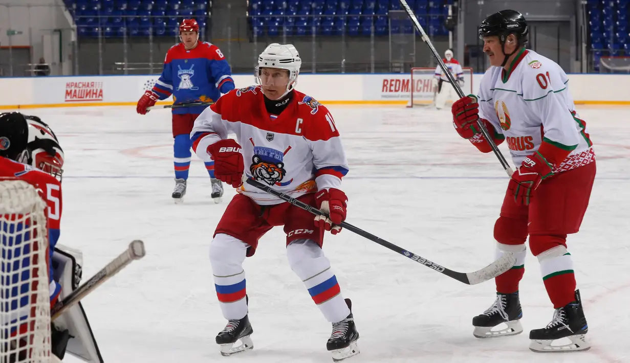 Presiden Rusia Vladimir Putin (kiri) dan Presiden Belarus Alexander Lukashenko (kanan) ikut serta dalam pertandingan hoki es di Shayba Arena, Resor Laut Hitam Sochi, Rusia, (15/2). (Sergei Chirikov / Pool / AFP)