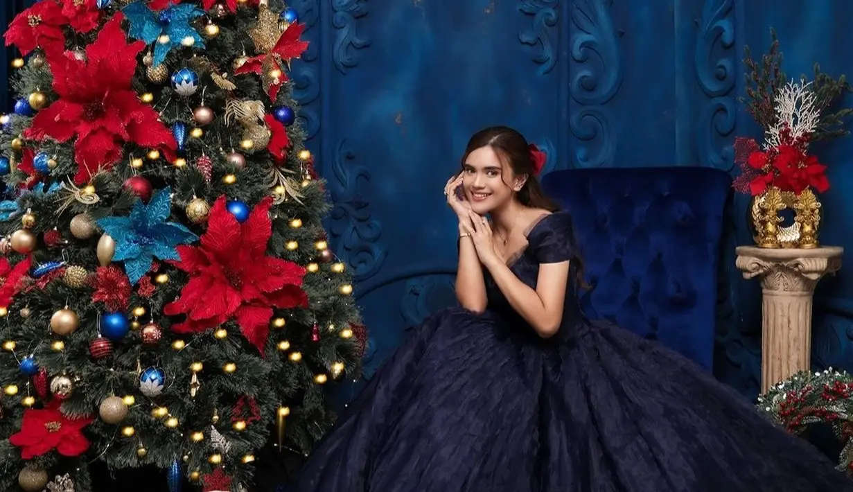 Audi Marissa terlihat anggun dalam makeup flawless. Sedangkan rambutnya ditata rapi dan diberi pita berwarna merah di belakang.