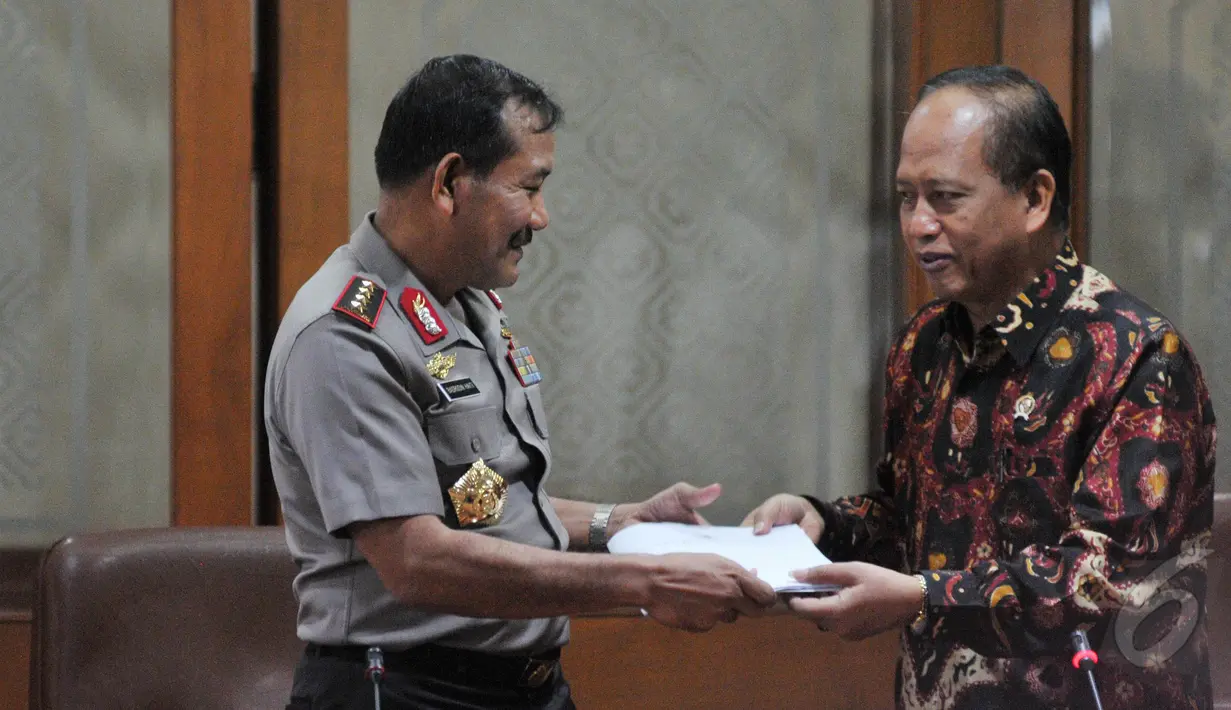 Menristek Mohammad Nasir memberikan dokumen berupa data perguruan tinggi ilegal kepada Kapolri Badrodin Haiti, Jakarta, Selasa (26/5/2015). (Liputan6.com/Herman Zakharia)