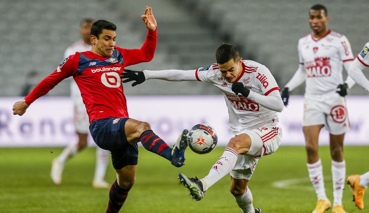 Gelandang Lille, Benjamin Andre (kiri) berebut bola dengan gelandang Brest, Romain Faivre dalam laga lanjutan Liga Prancis 2020/21 pekan ke-25 di The Stade Pierre Mauroy, Lille, Minggu (14/2/2021). Lille bermain imbang 0-0 dengan Brest. (AP/Michel Spingler)