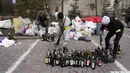 Anggota pertahanan sipil menyiapkan bom molotov di halaman di Kiev, Ukraina, Minggu (27/2/2022). Pihak berwenang Ukraina mengatakan bahwa pasukan Rusia telah memasuki kota terbesar kedua di Ukraina Kharkiv dan pertempuran di jalan-jalan. (AP Photo/Efrem Lukatsky)
