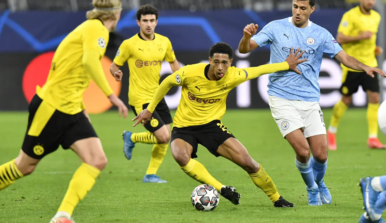 Gelandang Borrusia Dortmund, Jude Bellingham membawa bola dari kawalan gelandang Manchester City, Rodrigo pada pertandingan leg kedua perempat final Liga Champions di stadion Signal Iduna Park, Jerman (15/4/2021). The Citizens unggul agregat 4-2 atas Dortmund. (AP Photo/Martin Meissner)