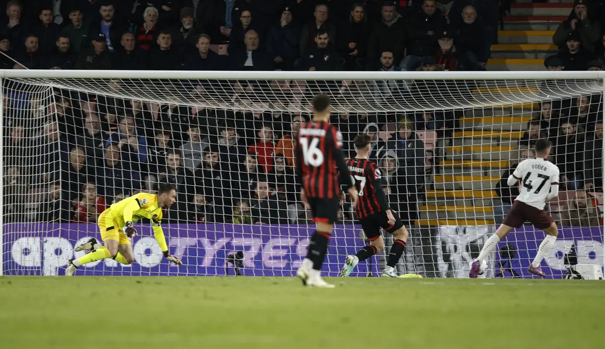 Pemain Manchester City, Phil Foden (kanan) mencetak gol ke gawang Bournemouth pada laga lanjutan Liga Inggris 2023/2024 yang berlangsung di Vitality Stadium, Bournemouth, Inggris, Minggu (25/02/2024) dini hari WIB. (AP Photo/David Cliff)
