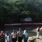 Komunitas Ciliwung bersama aparat  kepolisian mengikuti upacara bendera di Sungai Ciliwung, Jawa Barat, Jumat (17/8). Upacara di tengah aliran Sungai Ciliwung itu dalam rangka memperingati HUT ke-73 Republik Indonesia. (Liputan6.com/Immanuel Antonius)