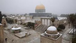 Salju menutupi the Dome of the Rock atau Kubah Batu di kompleks Masjid Al Aqsa pada pagi bersalju di Kota Tua Yerusalem (18/2/2021).  Dalam semalam, salju setinggi enam inci turun di kota tua Yerusalem. (AP Photo/Oded Balilty)