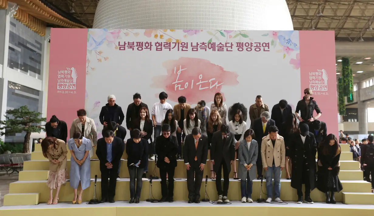 Girlband K-pop, Red Velvet bersama rombongan penyanyi dan musisi Korea Selatan membungkuk memberikan salam di hadapan media sebelum berangkat menuju Pyongyang, Korea Utara dari Bandara Internasional Gimpo, Seoul, Sabtu (31/3). (AP/Ahn Youg-joon)