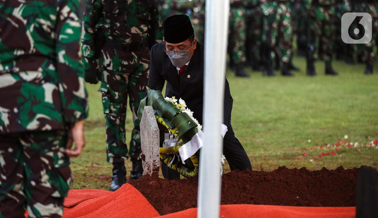 Menteri Sekretaris Negara (Mensesneg) RI Pratikno menaruh karangan bunga pada makam Menpan RB Tjahjo Kumolo saat prosesi pemakaman di Taman Makam Pahlawan Kalibata, Jakarta, Jumat (1/7/2022). Tjahjo Kumolo meninggal dunia di Rumah Sakit Abdi Waluyo Jakarta Pusat sekitar pukul 11.10 WIB. (Liputan6.com/Faizal Fanani)