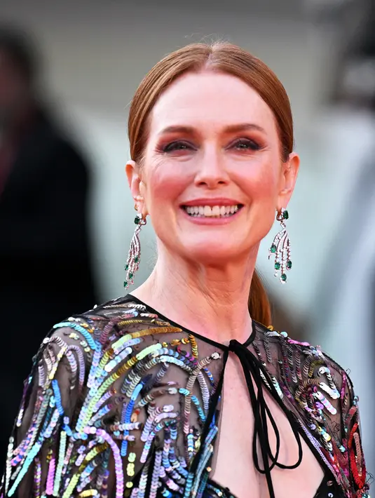 Aktris Amerika Serikat sekaligus Presiden Juri Venice Film Festival 2022 Julianne Moore tiba untuk upacara pembukaan dan pemutaran film "White Noise" di Venesia, Italia, Rabu (31/8/2022). Bintang Still Alice ini mengenakan bodysuit hitam berlapis bahan tipis yang dihiasi dengan payet efek kembang api serta menambahkan jubah serasi. (Tiziana FABI/AFP)