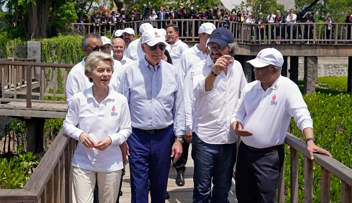Presiden Uni Eropa Ursula von der Leyen (kiri) dan Presiden Amerika Serikat Joe Biden (kedua kiri) bergabung untuk menanam pohon di sela-sela pertemuan KTT G20 di hutan mangrove Taman Hutan Raya Ngurah Rai, Denpasar, Bali, Indonesia, Rabu (16/11/2022). Para pemimpin dunia menanam mangrove bersama untuk menekankan peran penting menangani krisis iklim. (AP Photo/Alex Brandon, Pool)