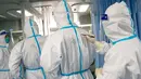 Seorang pekerja medis menulis nama rekan mereka pada baju pelindung untuk membantu identifikasi menyusul wabah virus corona di Rumah Sakit Zhongnan, Wuhan University, Wuhan, Provinsi Hubei, China, Jumat (24/1/2020). Penemuan virus corona pertama kali diungkapkan oleh dr Li Wenliang. (Xiong Qi/Xinhua