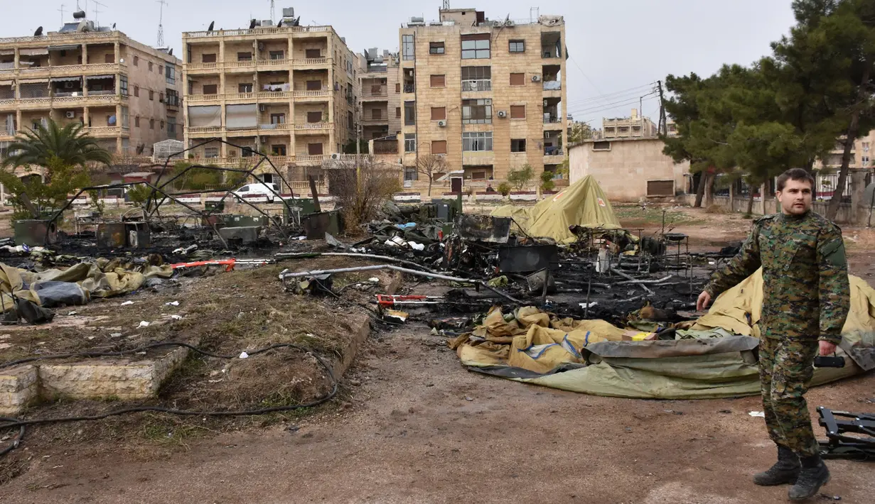 Seorang tentara Rusia memeriksa kerusakan sebuah rumah sakit lapangan militer Rusia di Aleppo, Senin (5/12). Pejabat Kemenhan Rusia mengatakan, pemberontak Suriah telah mengarahkan tembakan artileri ke rumah sakit lapangan tersebut. (GEORGE OURFALIAN/AFP)