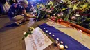 Seikat bunga diletakkan di atas kertas bertuliskan  "Stop Russian terrorism!" di depan Kedutaan Besar Belanda di Kiev, Ukraina, Jumat (17/7/14). (AFP PHOTO/Sergei Supinsky)