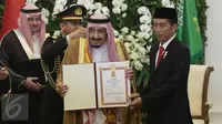 Raja Salman memperlihatkan piagam penghargaan yang diperolehnya dari Pemerintah Indonesia di Istana Bogor, Jawa Barat, Rabu (1/2). Raja Salman mendapat penghargaan Bintang Republik Indonesia Adipurna. (Liputan6.com/Angga Yuniar)