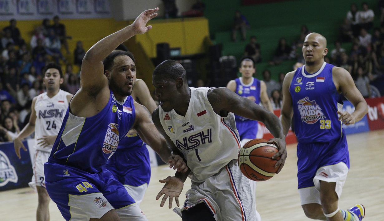 Pebasket NSH Jakarta, Anthony Simpson, berusaha melewati pemain Satria Muda, Alexandrod Lowhorn, pada laga semi final IBL 2019 di GMSB Kuningan, Jakarta, Minggu (10/3). Satria Muda menang 72-48 atas NSH Jakarta. (Bola.com/M Iqbal Ichsan)