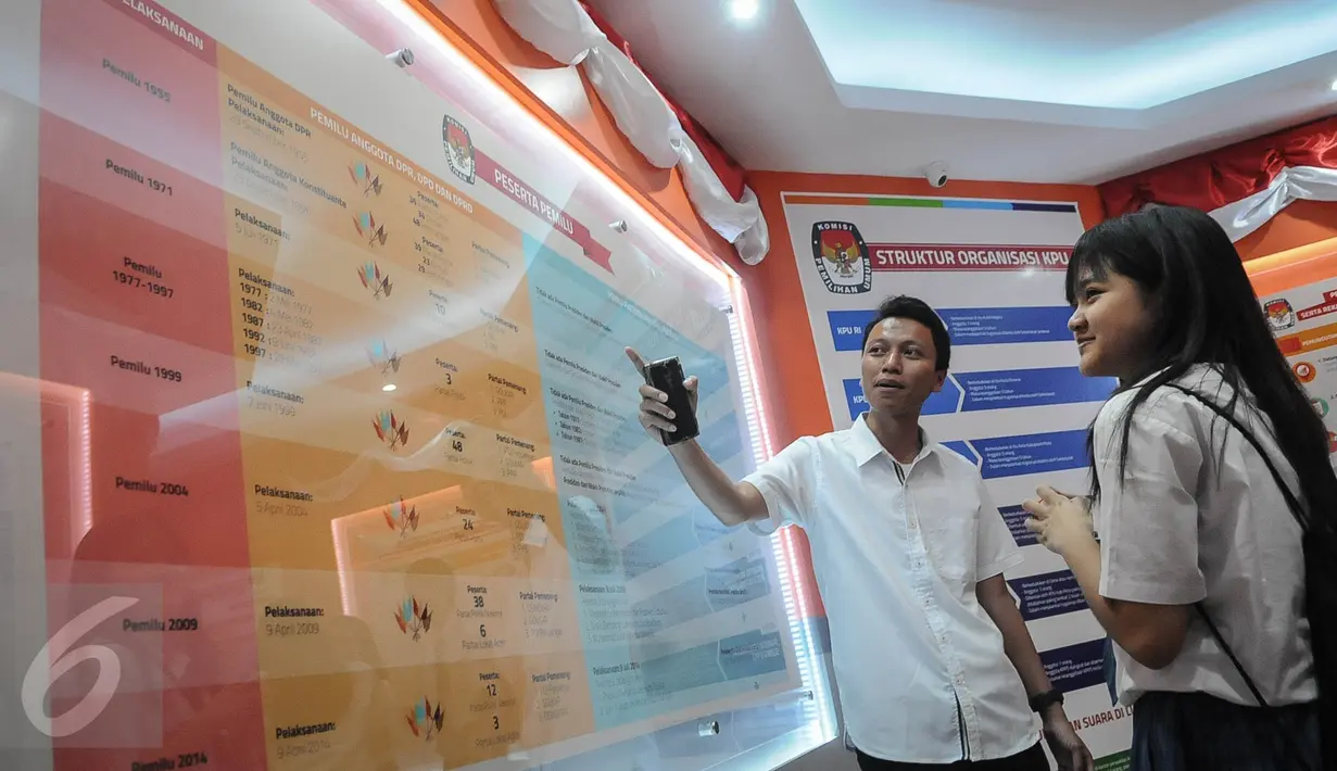 Petugas menjelaskan tabel tata cara pemilihan umum kepada Pelajar SMA Permai Pluit di KPU Pusat, Jakarta, Selasa (18/10). KPU menggelar sosialisasi bagi pemilih pelajar untuk mengetahui tata cara yang benar bagi pemilih pemula (Liputan6.com/Faizal Fanani)