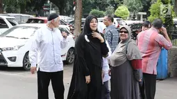 Istri Ustaz Ahmad Alhabsyi, Putri Aisah Aminah berjalan memasuki Gedung Ditreskrimum Polda Metro Jaya, Rabu (31/5). Putri menjalani pemeriksaan atas tuduhan perampasan disertai kekerasan terhadap asisten rumah tangganya. (Liputan6.com/Herman Zakharia)