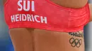 Joana Heidrich - Pemain voli pantai wanita Swiss Joana Heidrich memiliki tato bertuliskan Rio 2016 di sisi tulang rusuknya. Tato tersebut sebagai tanda Olimpiade pertama yang ia ikuti sepanjang kariernya. (Foto/AFP/Angea Weiss)