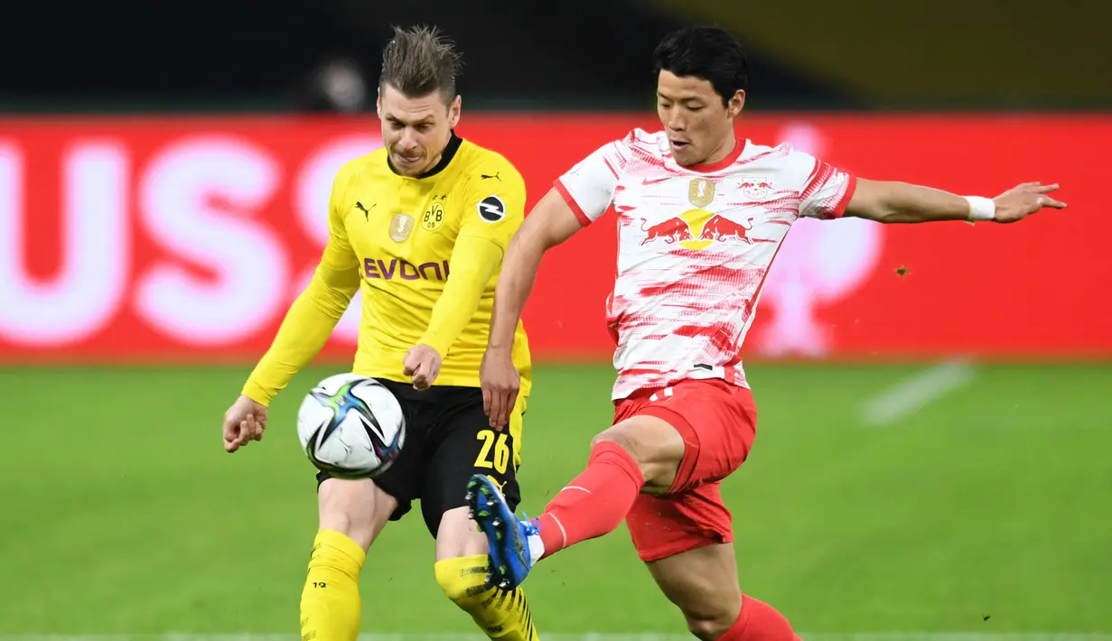 Bek Borussia Dortmund, Lukasz Piszczek (kiri) berebut bola dengan striker RB Leipzig, Hwang Hee-chan dalam laga final DFB Pokal 2020/2021 di Olympiastadion, Berlin, Kamis (13/5/2021). Dortmund menang 4-1 atas Leipzig dan menjadi juara. (AFP/Annegret Hilse/Pool)