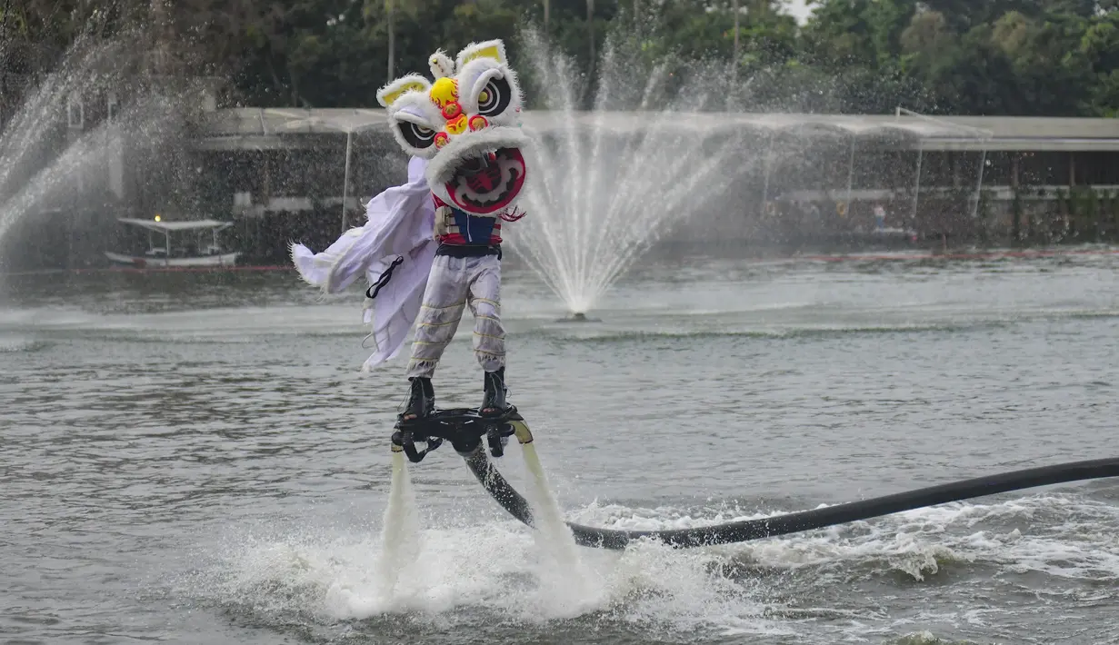 Atraksi spektakuler ini menampilkan barongsai yang seolah "terbang" dan menari di atas permukaan air danau dengan koreografi yang dinamis. Tampak dalam foto, penampil mengenakan kostum barongsai beratraksi Aerial Lion Dance di Danau Senayan Park, Jakarta, 14 Februari 2026. (merdeka.com/Arie Basuki)