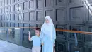 Berpenampilan serasi dengan sang anak, Larissa Chou memilih nuansa biru muda yang lembut. Gamis cantik biru muda, dipadunya dengan hijab syar'i berwarna putih. [Foto: Instagram/larissachou]