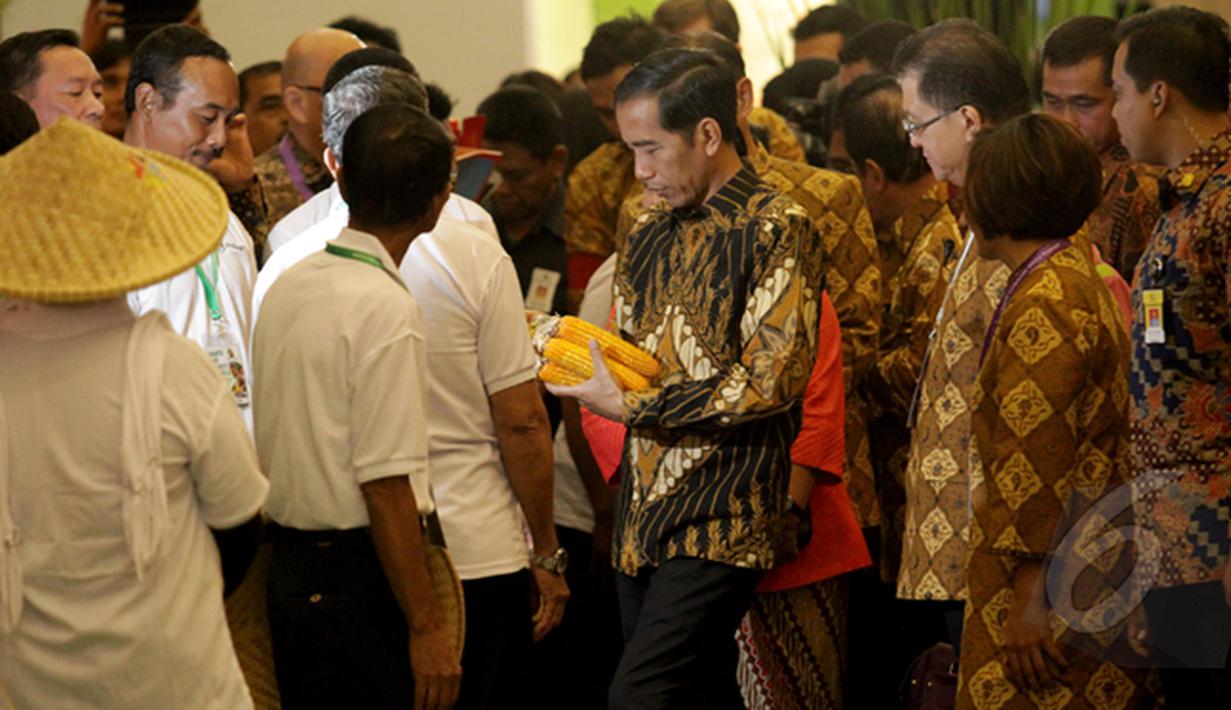 Presiden Joko Widodo terlihat membawa jagung di Jakarta Food Security Summit, Jakarta, Kamis (12/2/2015).  Acara ini ditujukan untuk mewujudkan karya dan komitmen para pelaku usaha dalam skala nasional dan internasional. (Liputan6.com/Faizal Fanani)