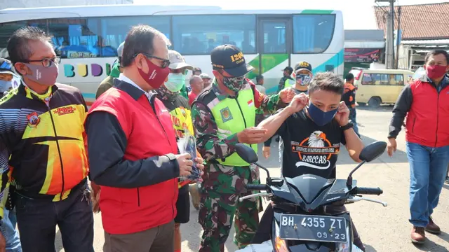 Area Manager PGE Area Karaha Roy Bandoro Swandaru bersama Komandan Rayon Militer (Danramil) 1204/Ciawi Mayor Inf Deni Zenal Muttaqin, tengah membagikan masker kepada masyarakat di terminal Ciawi, Tasikmalaya
